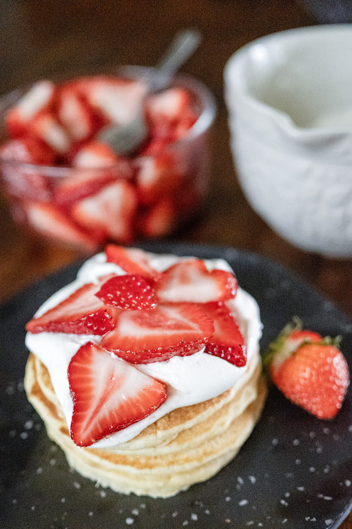 sourdough discard pancake stack with strawberries and whipped cream
